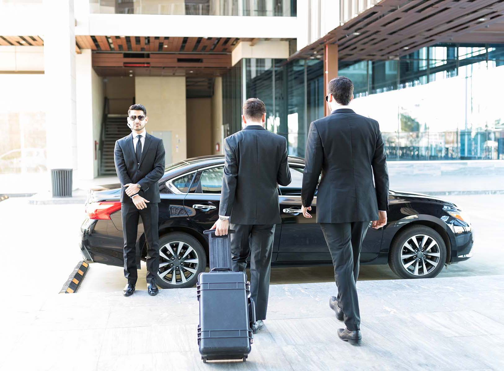 Executive-protection team near a vehicle