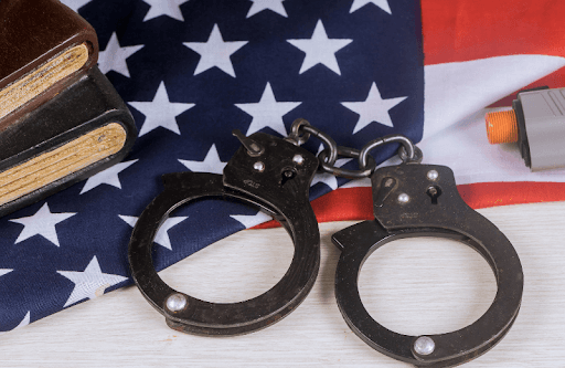 Handcuffs resting on an American flag