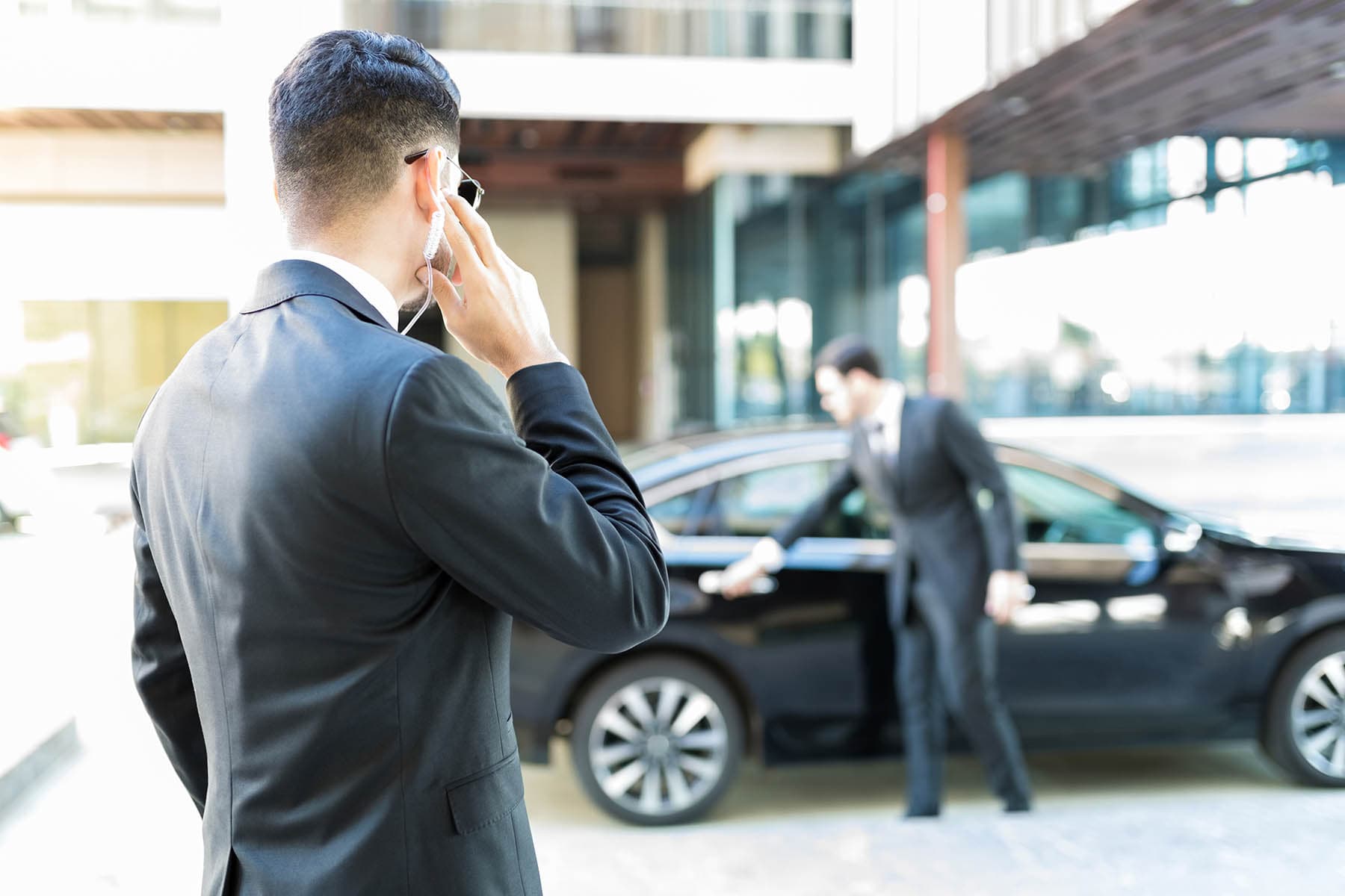 Security officer communicating near a vehicle