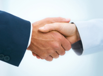 Cropped view of two business executives shaking hands