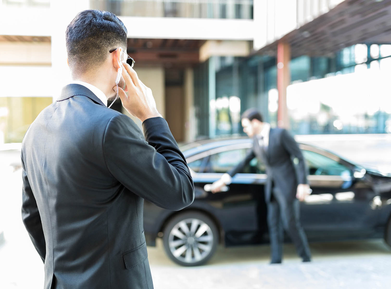 Protection agent in suit getting constant updates through earpiece to avoid danger